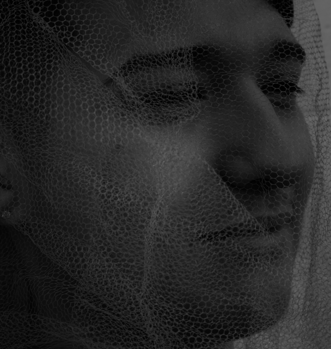 Police officer writing a report beside a car.