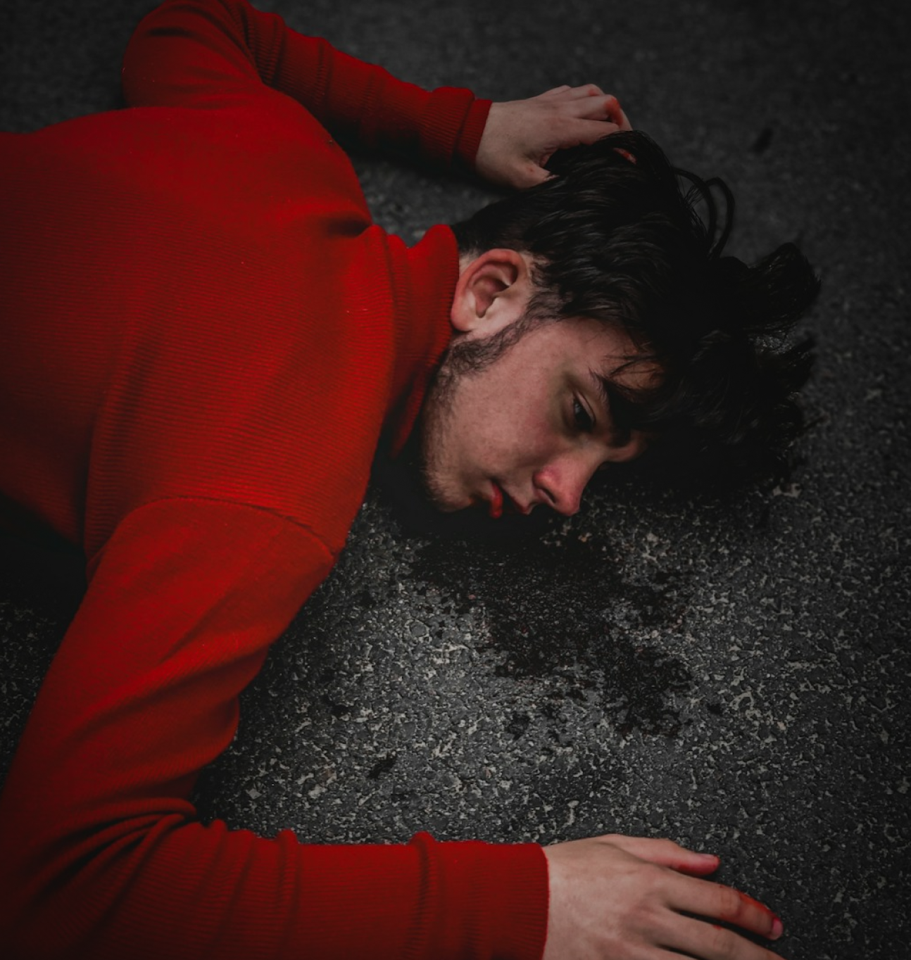 Police officer writing a report beside a car.