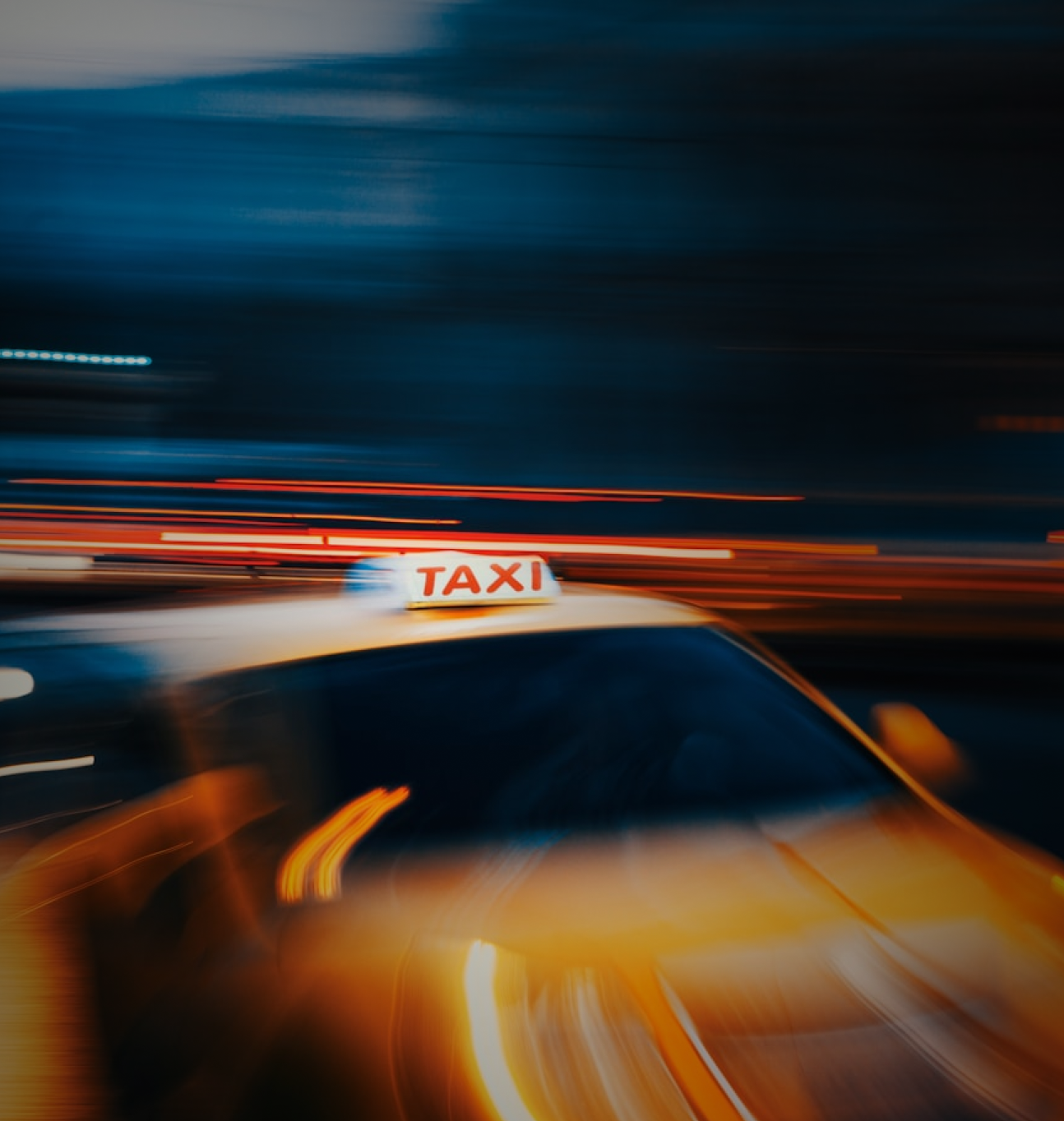 Police officer writing a report beside a car.