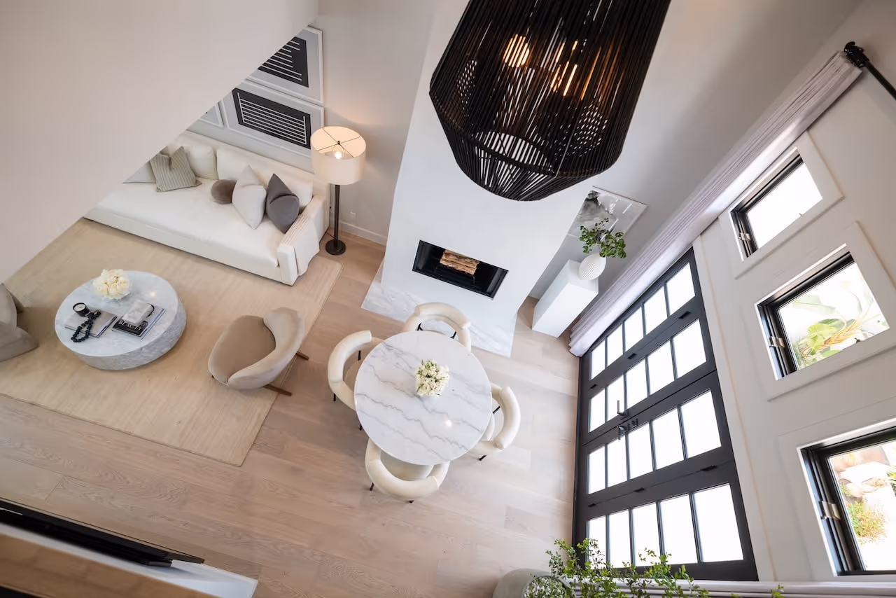 Overhead view of living room with custom fireplace cabinetry, soft-toned furniture, and airy architecture from Gwyneth Paltrow’s Celebrity IOU project. Cabinetry by Marvel Cabinetry for HGTV’s Property Brothers: Celebrity IOU - Gwyneth Paltrow