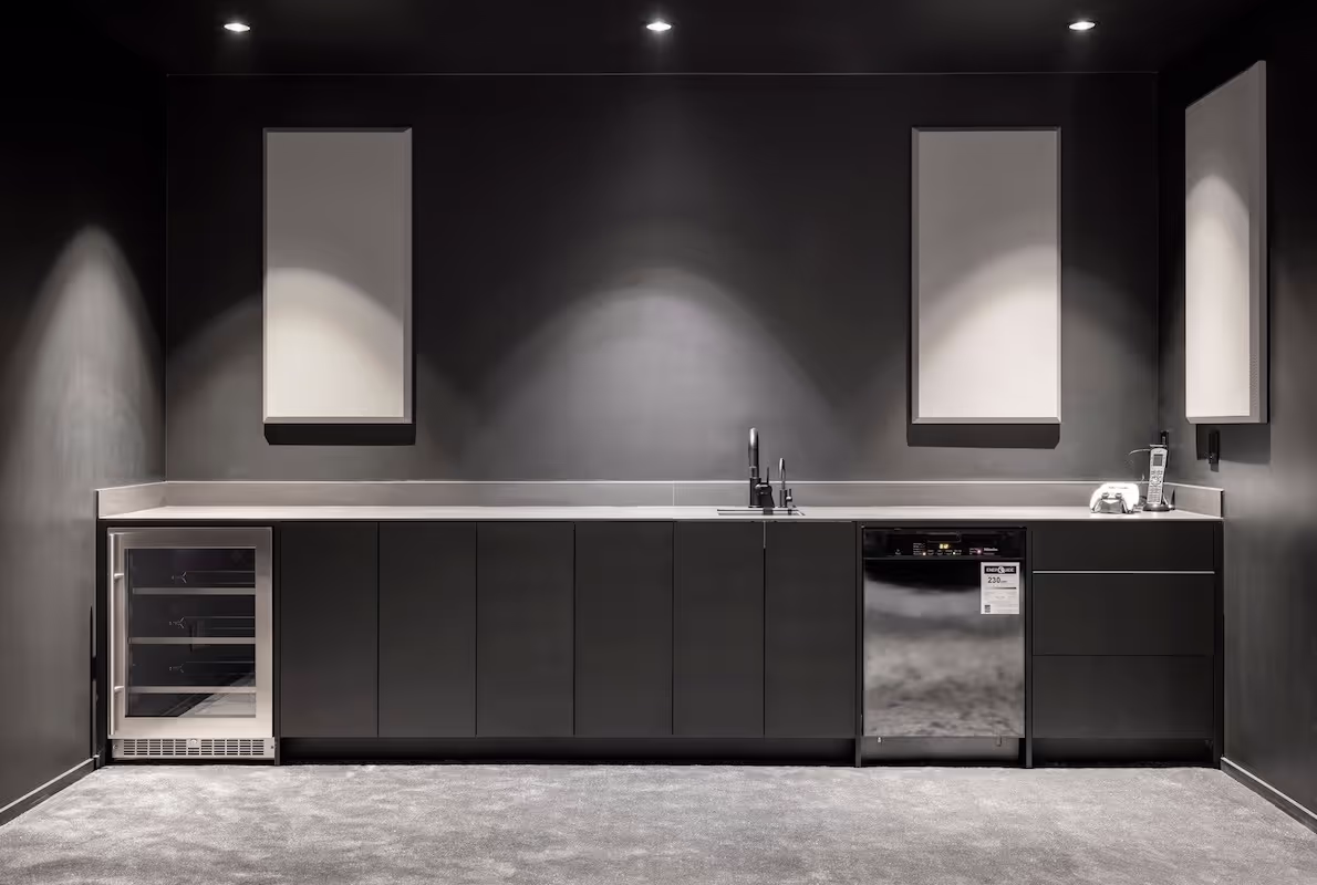 Contemporary lower bar area with full-height custom cabinetry, beverage fridge, and sleek shelving. Cabinetry by Marvel Cabinetry.