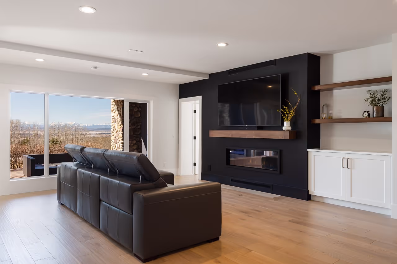 Living room built-ins featuring a modern fireplace, white cabinetry, and contrasting dark entertainment millwork. Cabinetry by Marvel Cabinetry.