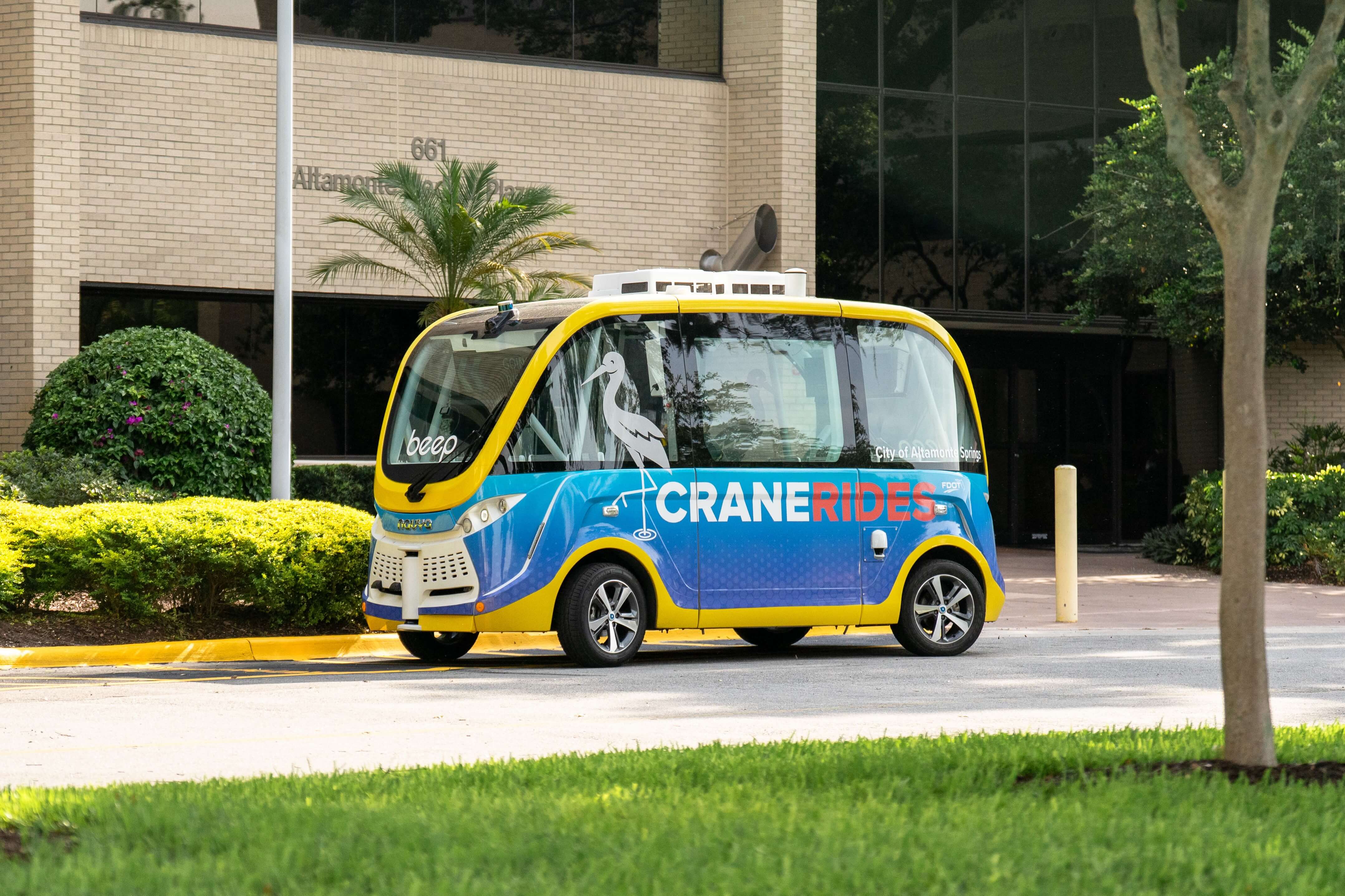 CraneRIDES shuttle parked in front of the AdventHealth hospital building