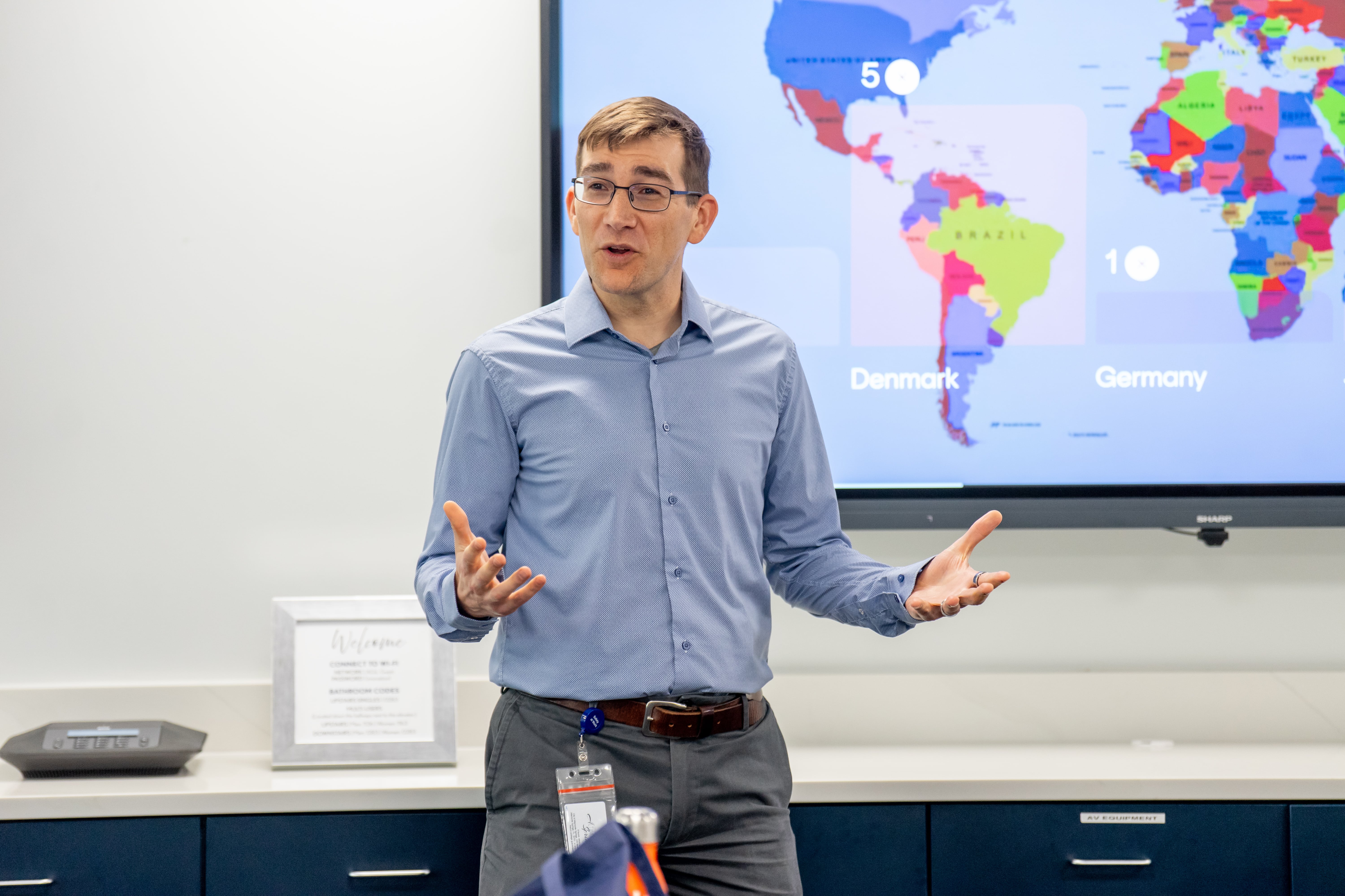 Man standing in front of a map presenting a lecture