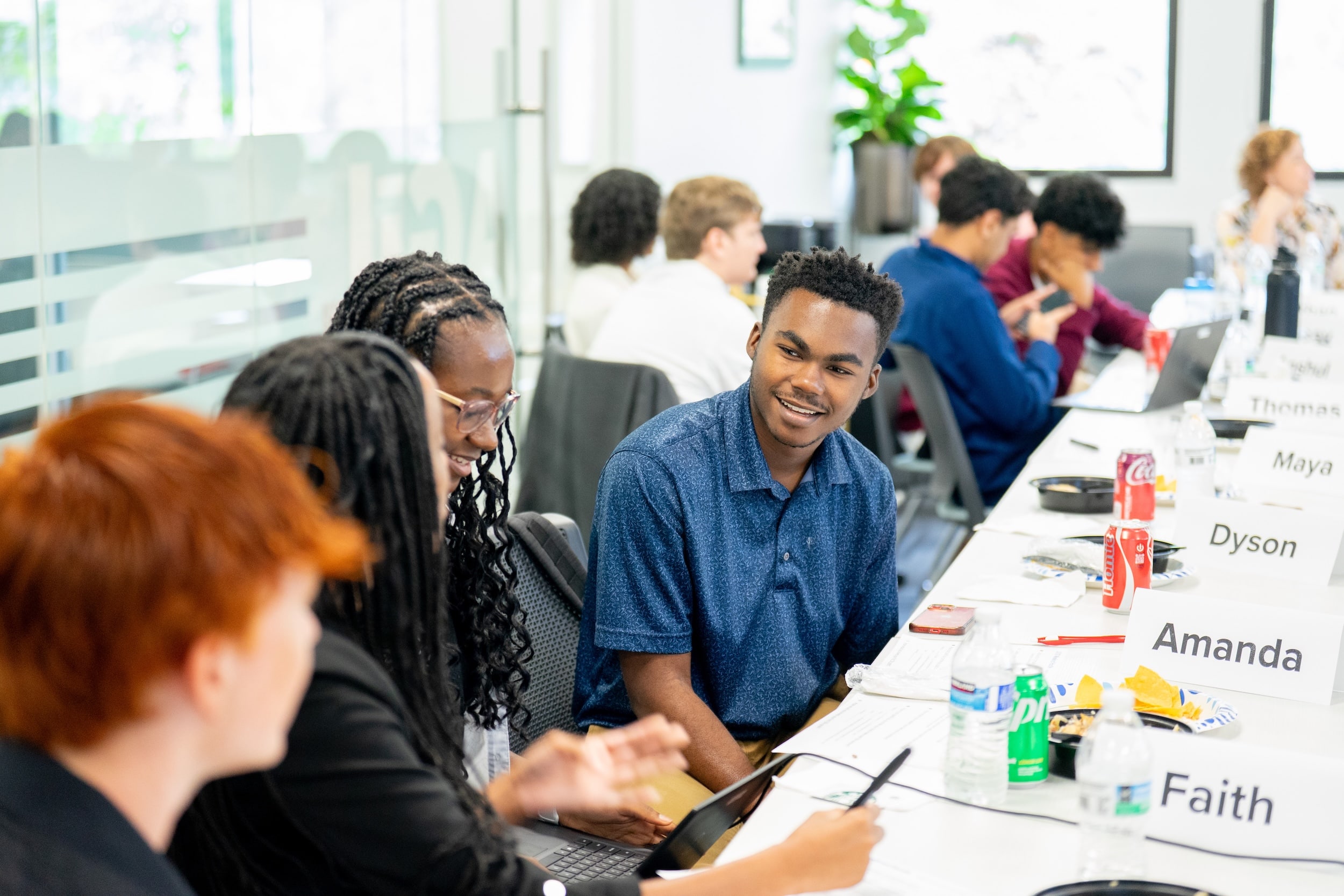 Student interns sitting a table and talking to each other