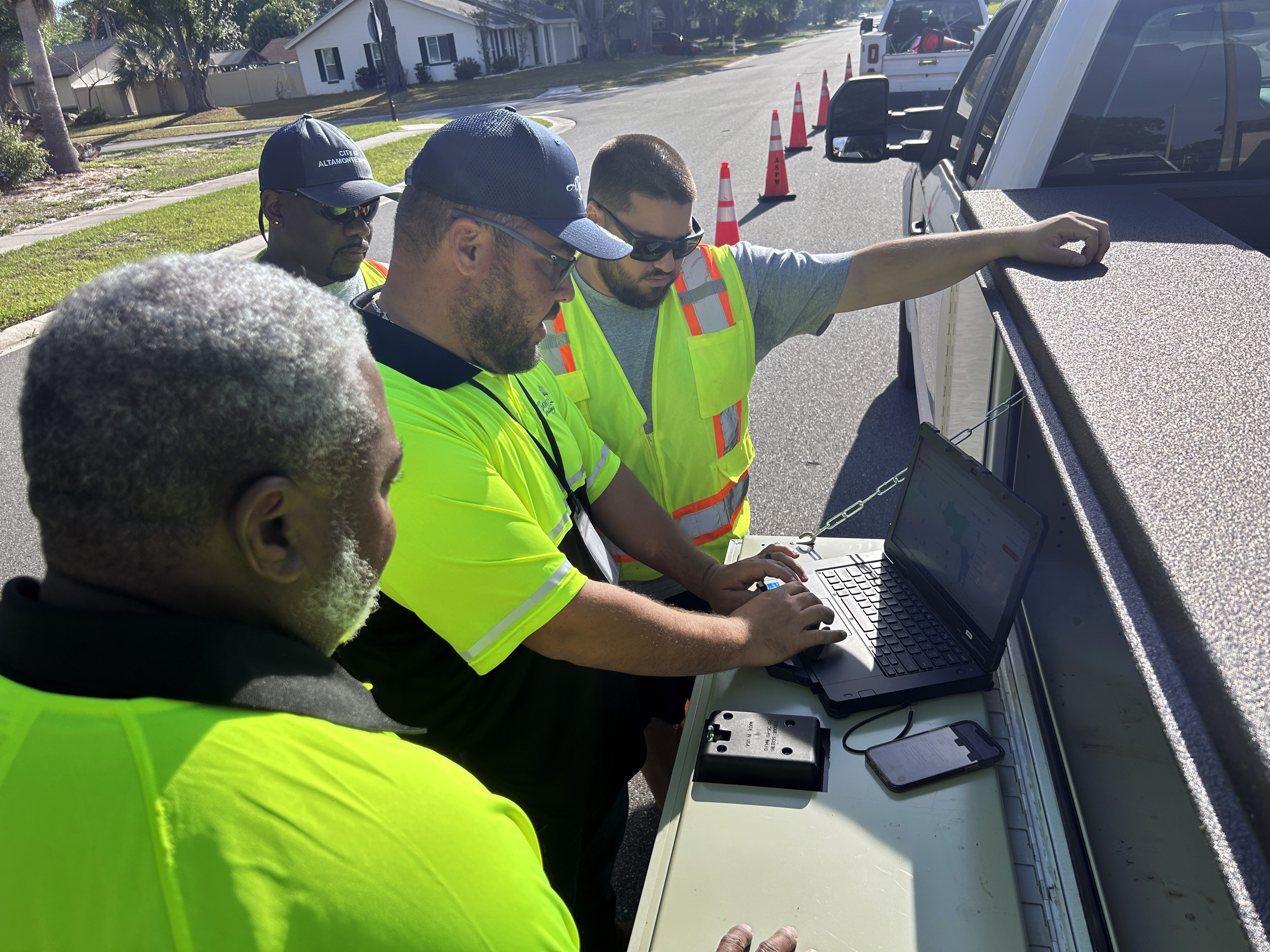 City staff gather around a computer to enter road condition information