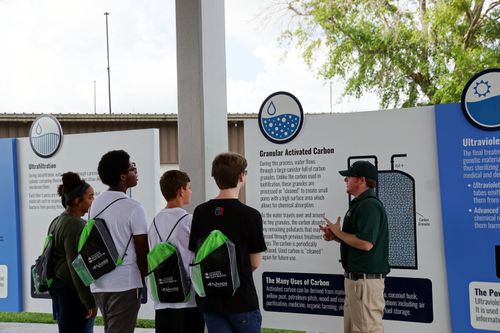 Staff member teaches students about the pureALTA water process