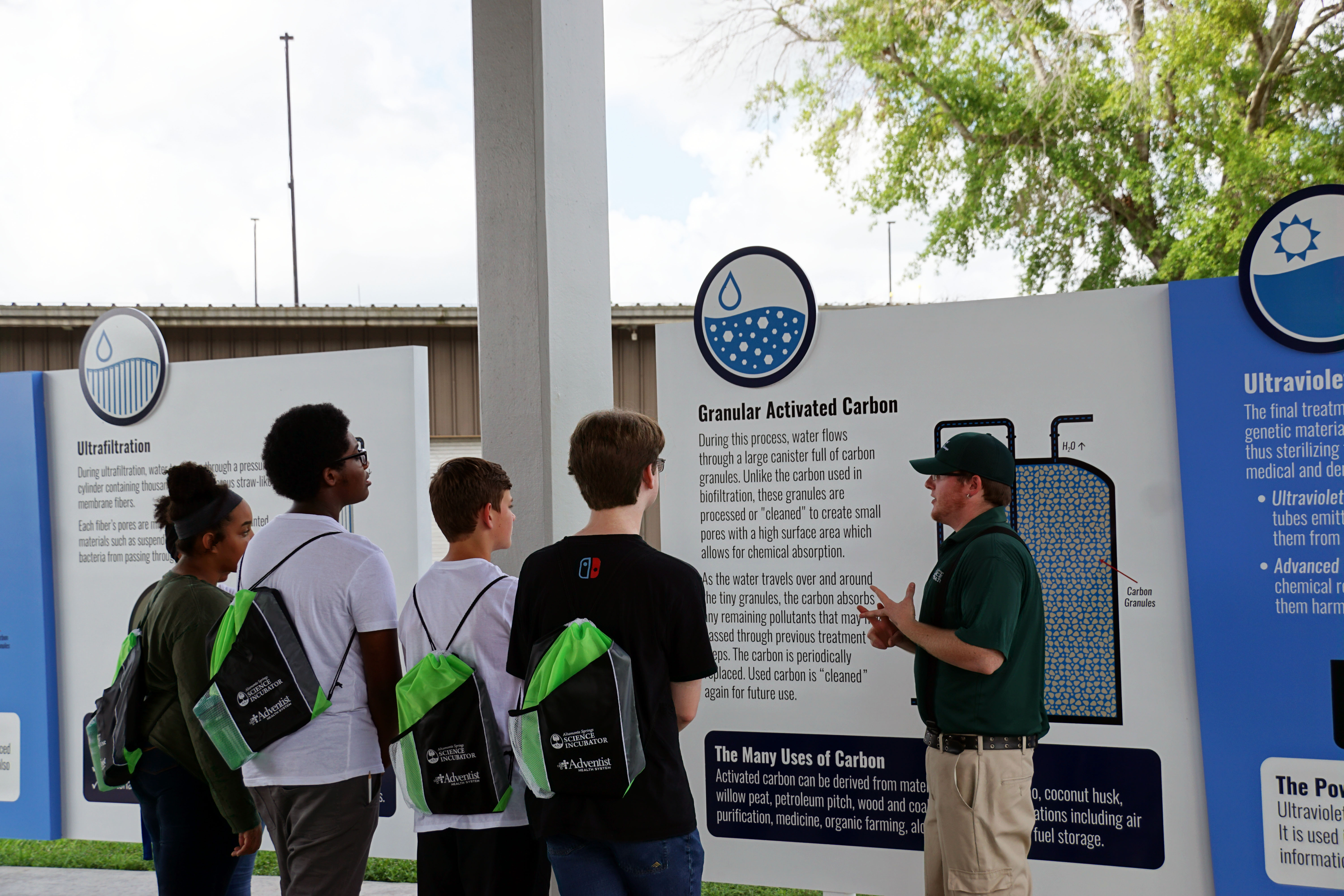 Staff member teaches students about the pureALTA water process