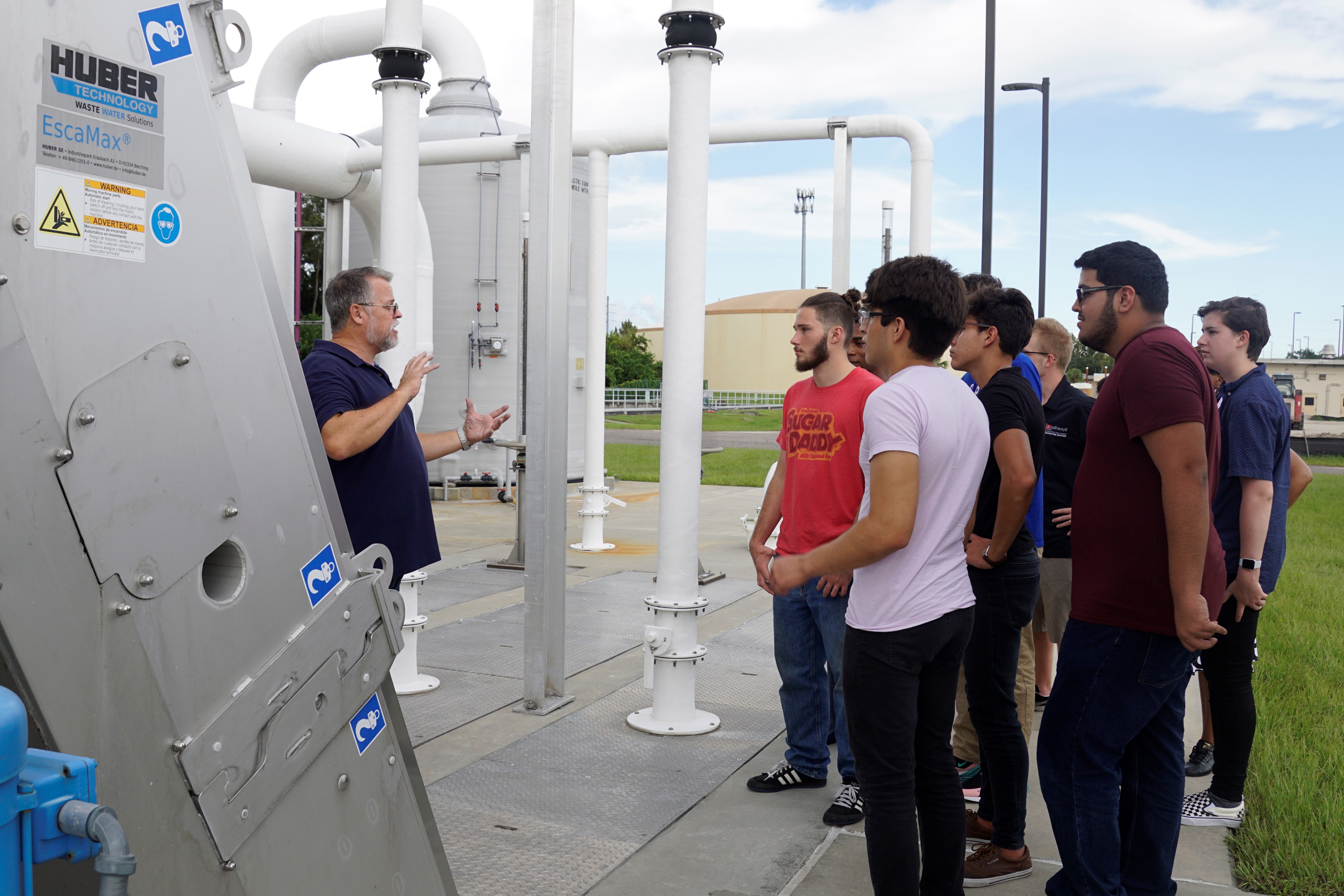 Course instructor leading a tour of students through the water plant
