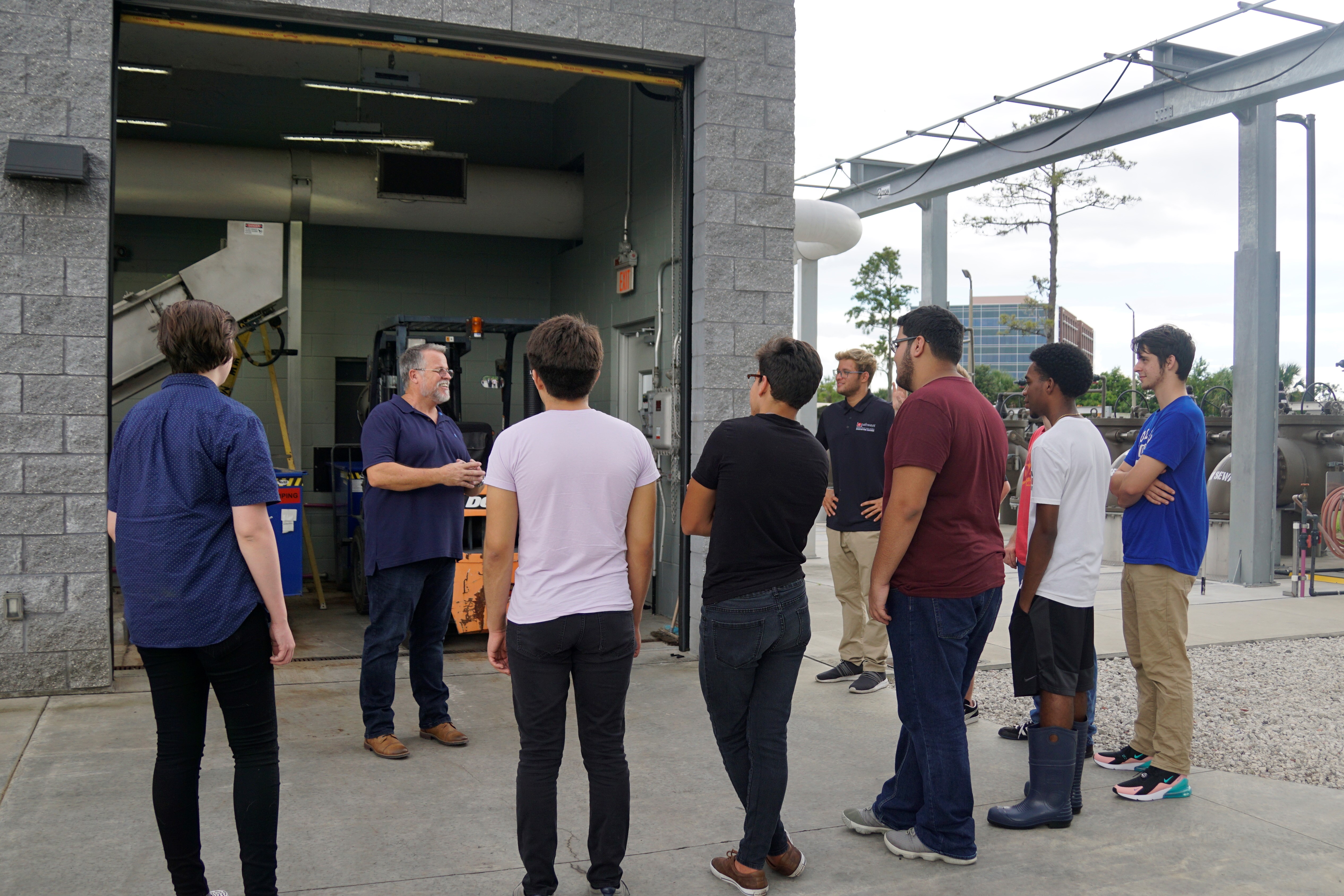 Course instructor leading a tour of students through the water plant