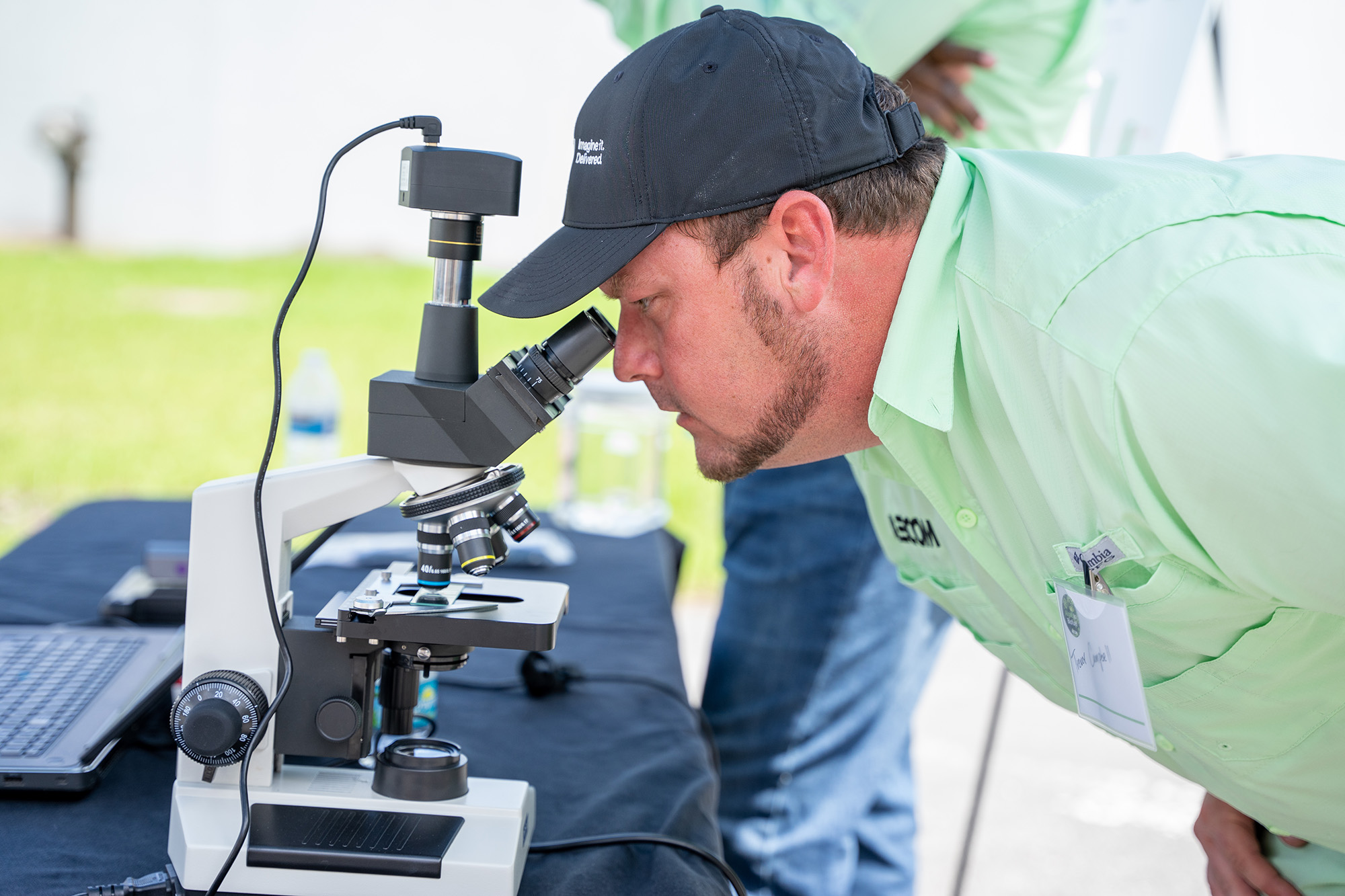 Man looks into microscope
