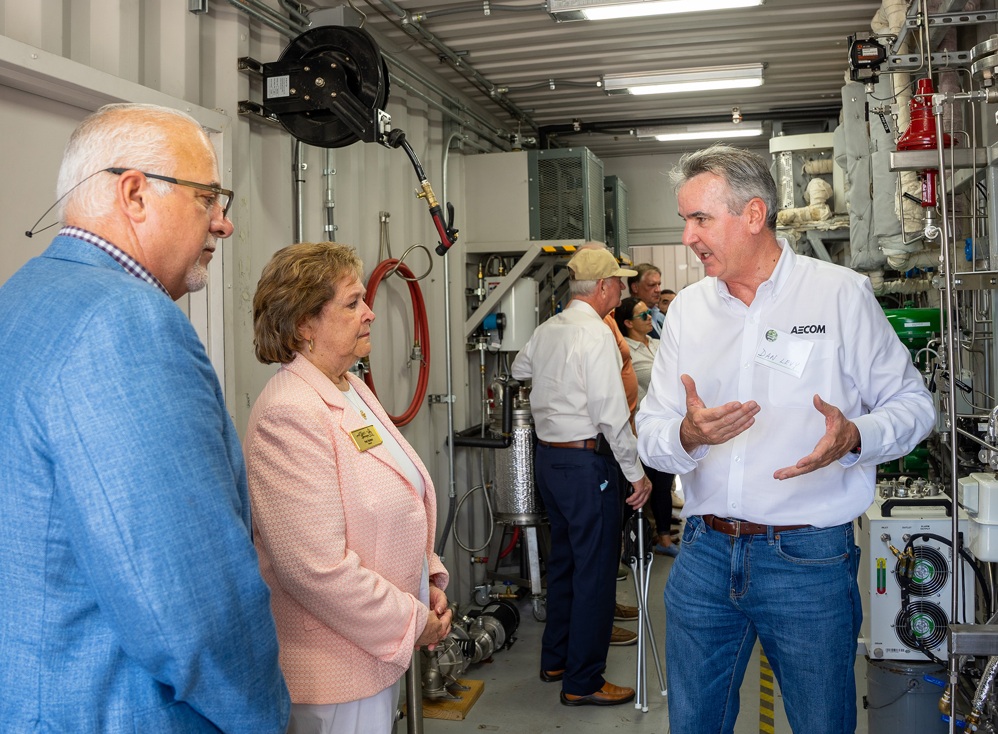 Man gives a tour of the equipment used to turn biosolids to biofuel