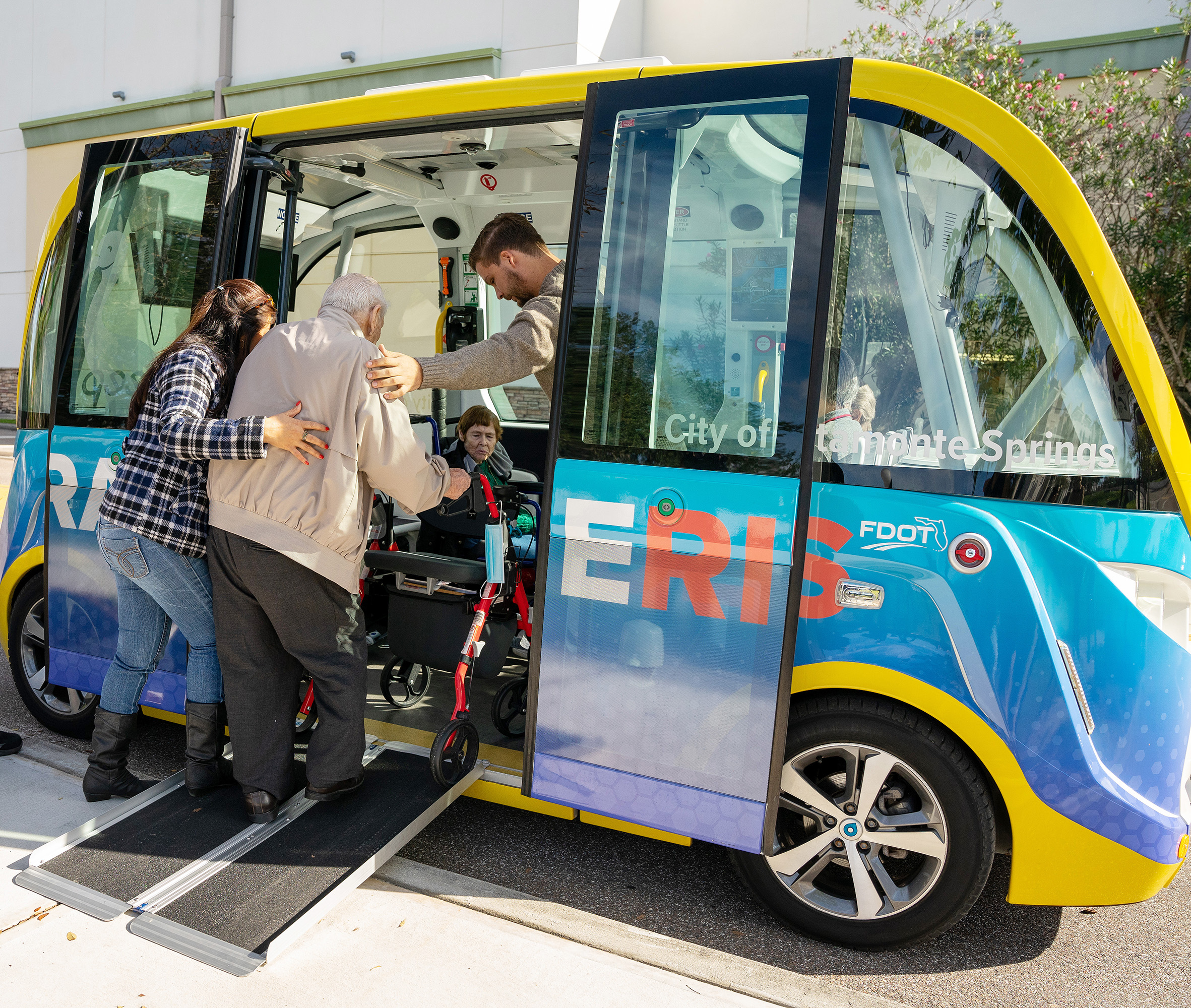 A man with a walker boards the CraneRIDES shuttle