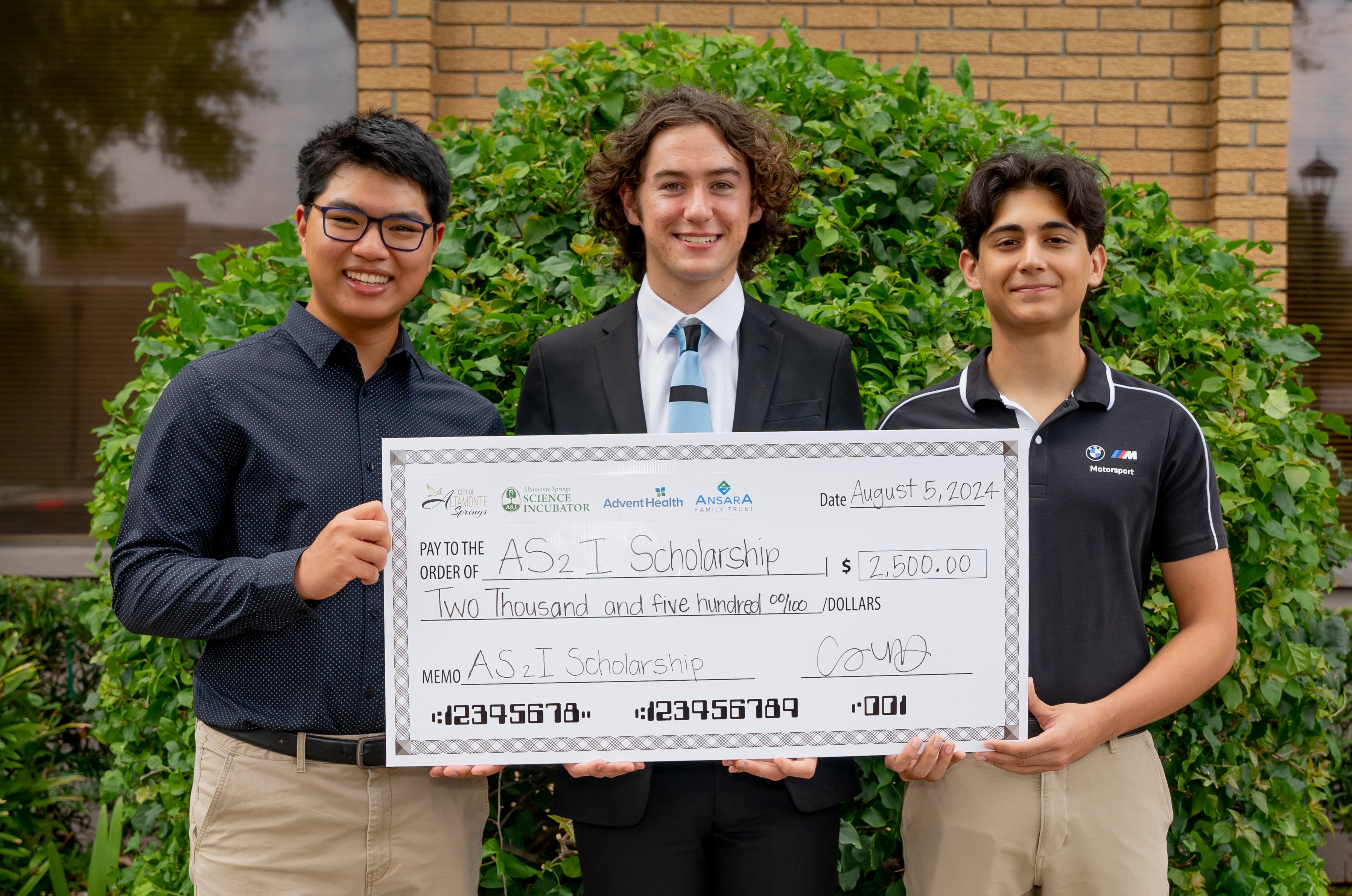 2024 Student scholarship winners pose with giant check
