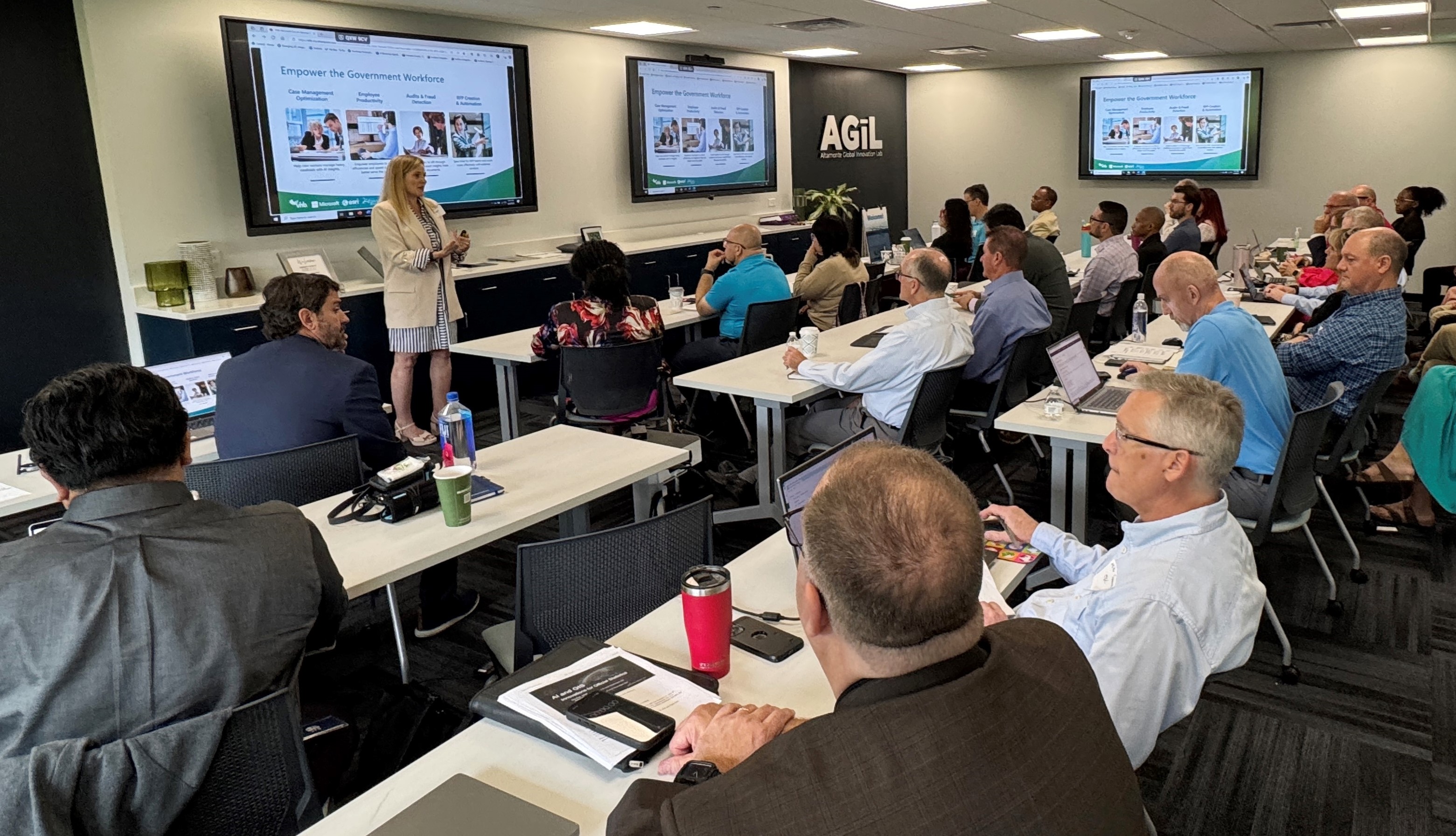 Wide view of classroom with participants listening to a presentation