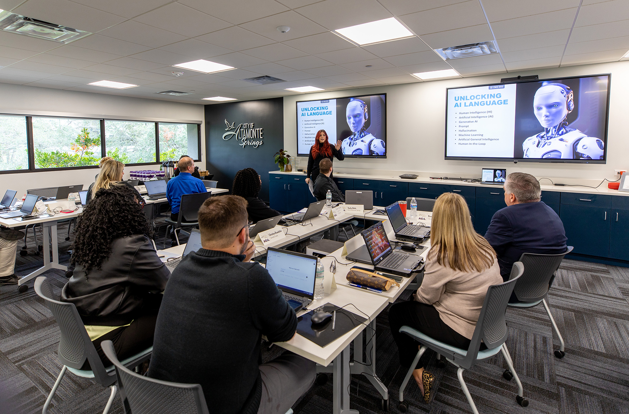 Group of event participants sitting at tables in a classroom