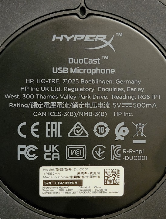 A photo of the underside of a HyperX microphone base stand, showing a single SN / product info sticker in the bottom middle. .