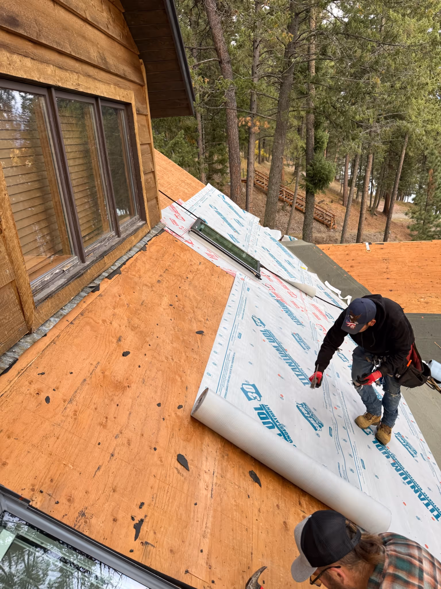 roofers installing new roofing underlayment