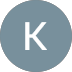 Circle with a blue-gray background and a white capital letter K in the center.