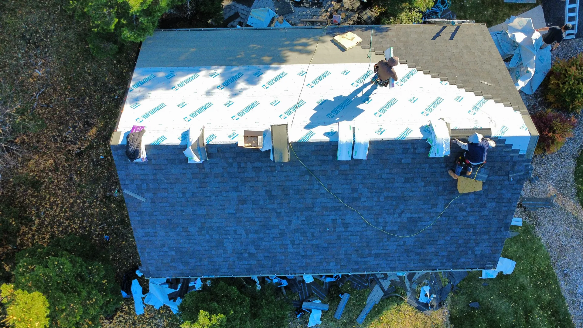 Aerial view of an asphalt shingle reroof in progress on a Kalispell ranch home.
