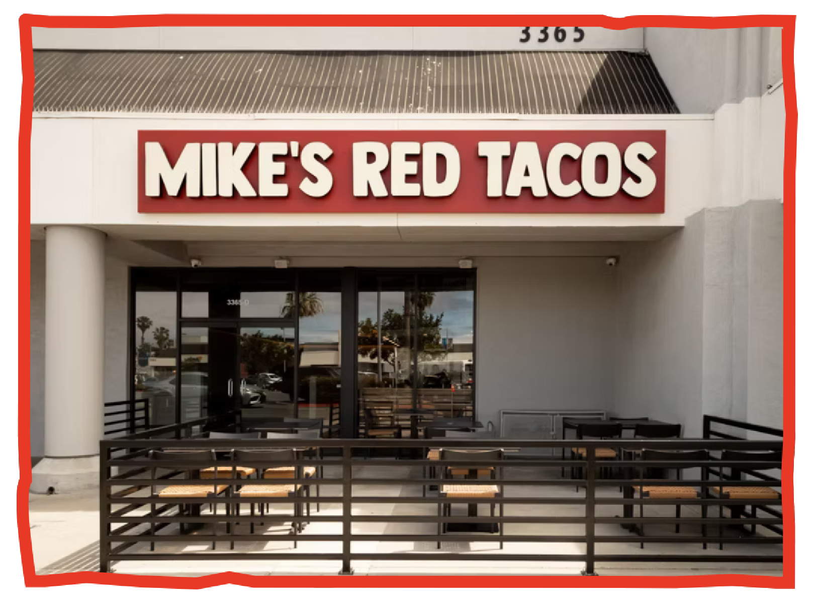 Outdoor seating area with tables and chairs in front of Mike's Red Tacos restaurant.