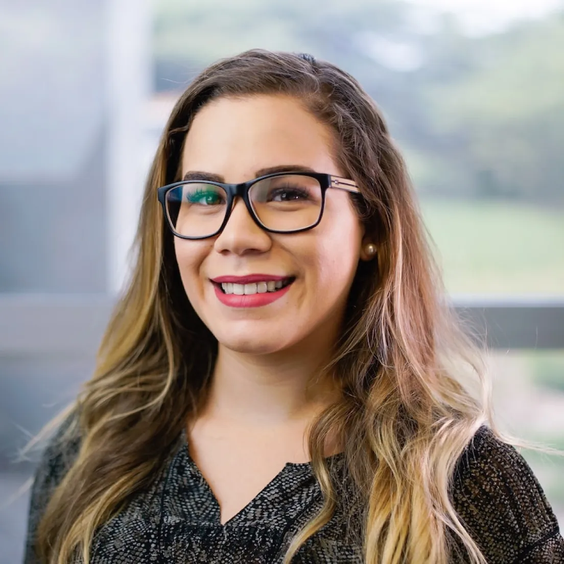 a woman with glasses smiling at the camera - volunteer - best organization website webflow CMS template