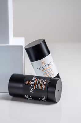Two Entourus body stick containers on white steps with soft shadows, product photography by Photos by Lars.