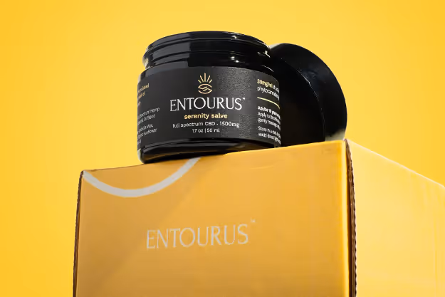 Entourus Serenity Salve jar resting on yellow box against yellow backdrop, product photography by Photos by Lars.