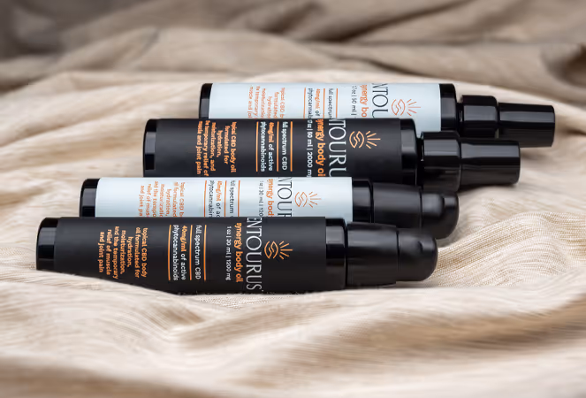 Entourus pump bottles stacked on beige fabric, product photography by Photos by Lars.