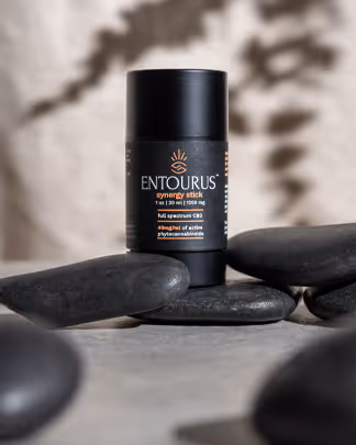 Entourus body stick on smooth black stones, product photography by Photos by Lars.