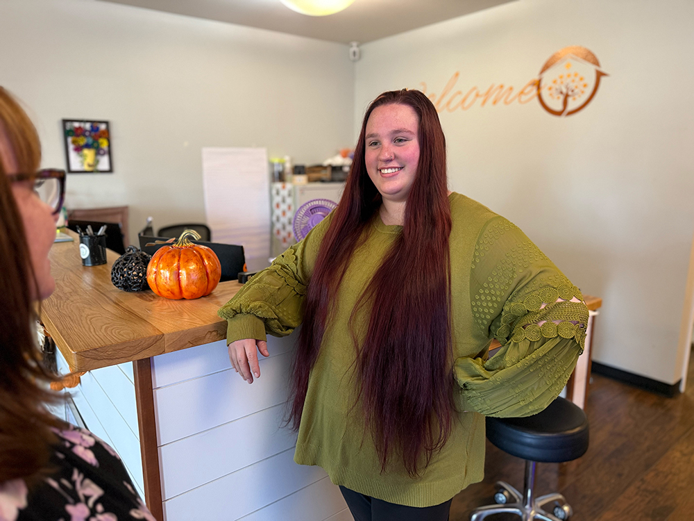 Maisie greeting a patient in the waiting area of Homestead Family Medicine