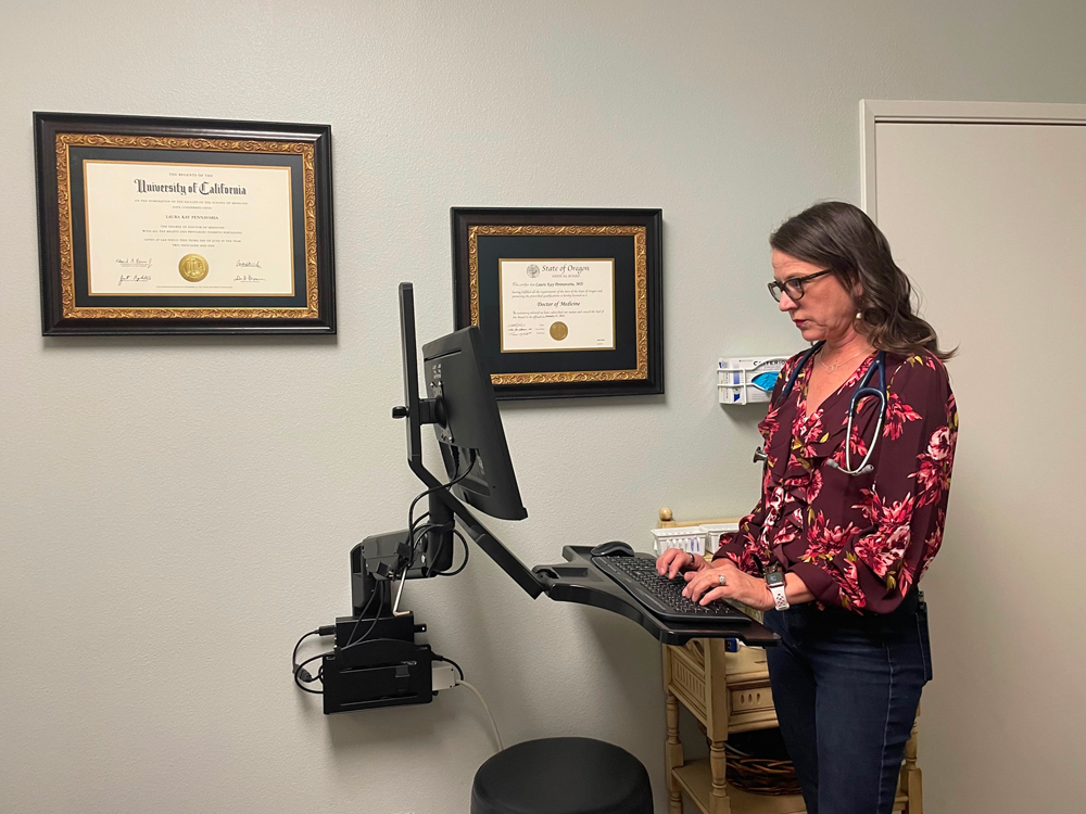 Dr. P standing in the exam room at Homestead Family Medicine.