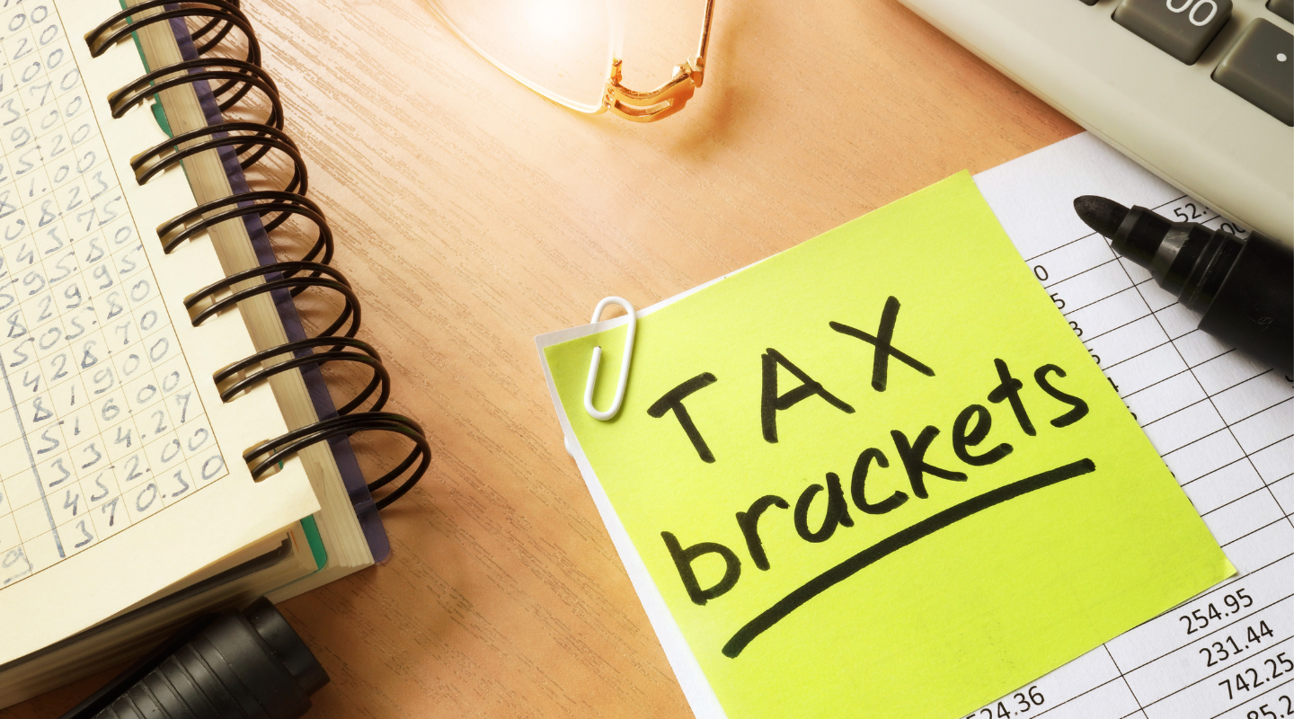 Sticky note labeled “Tax brackets”