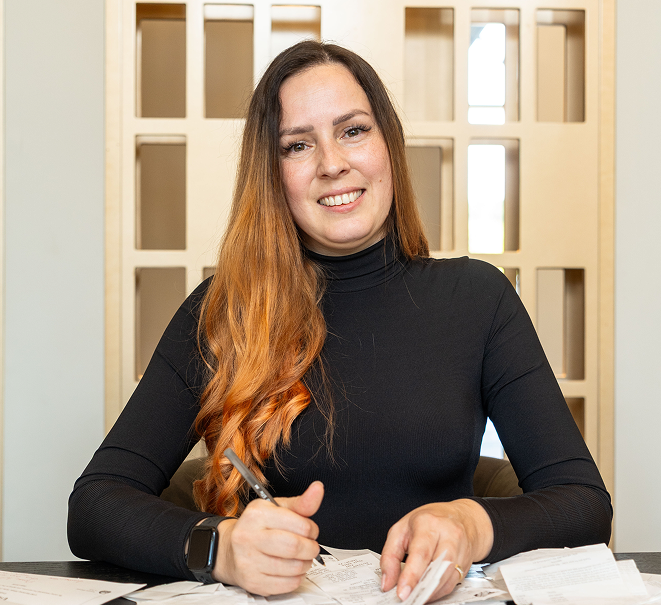 Tax professional completing paperwork and meeting with clients.