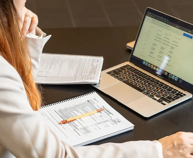 Tax professional analyzing financial spreadsheets on a laptop