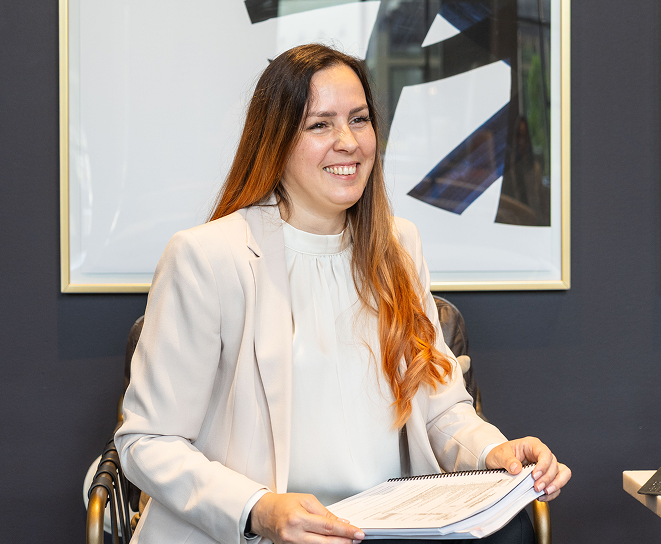 Tax professional reviewing documents during a client meeting.