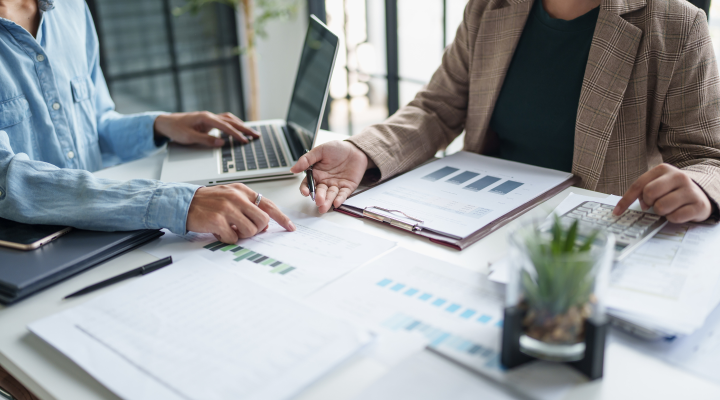 Tax and financial professionals reviewing charts and documents during a retirement planning discussion.
