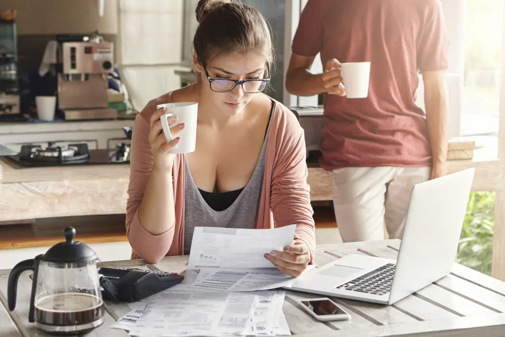 Woman reviewing bills and tax papers at home