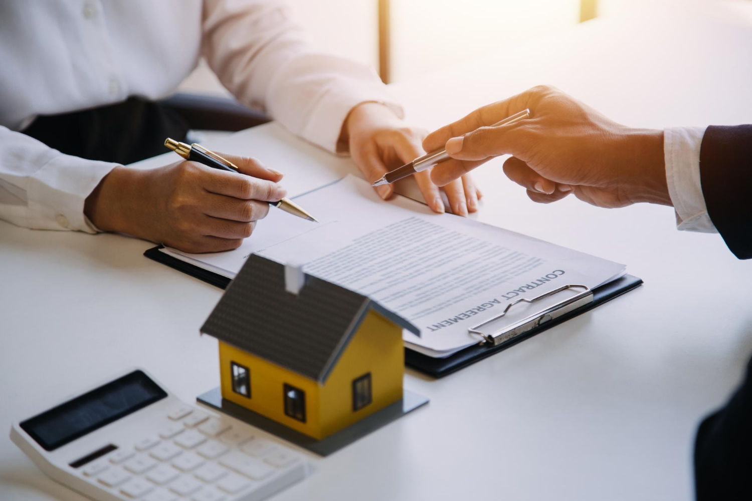 People signing a contract