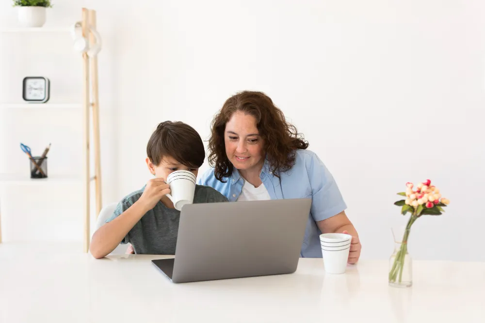 Parent and child looking at a laptop together