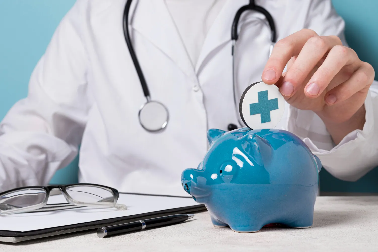 Doctor placing coin into blue piggy bank