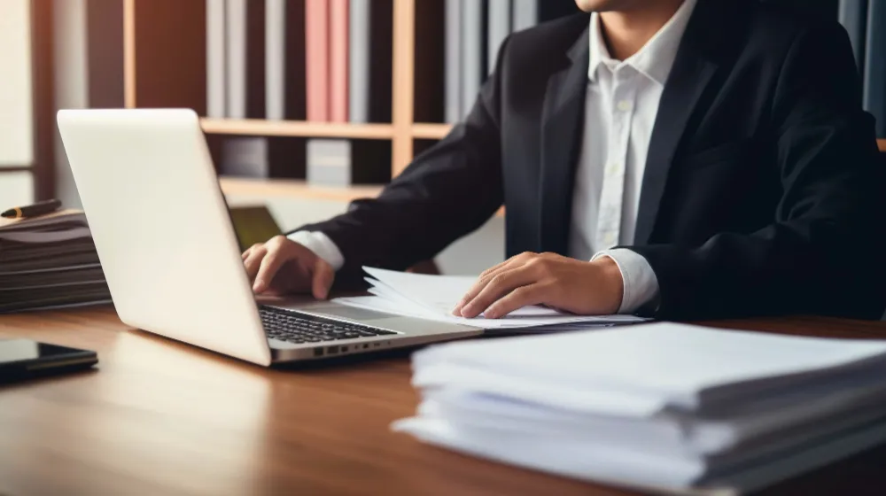 Business owner reviewing documents while managing LLC taxes and financial records.