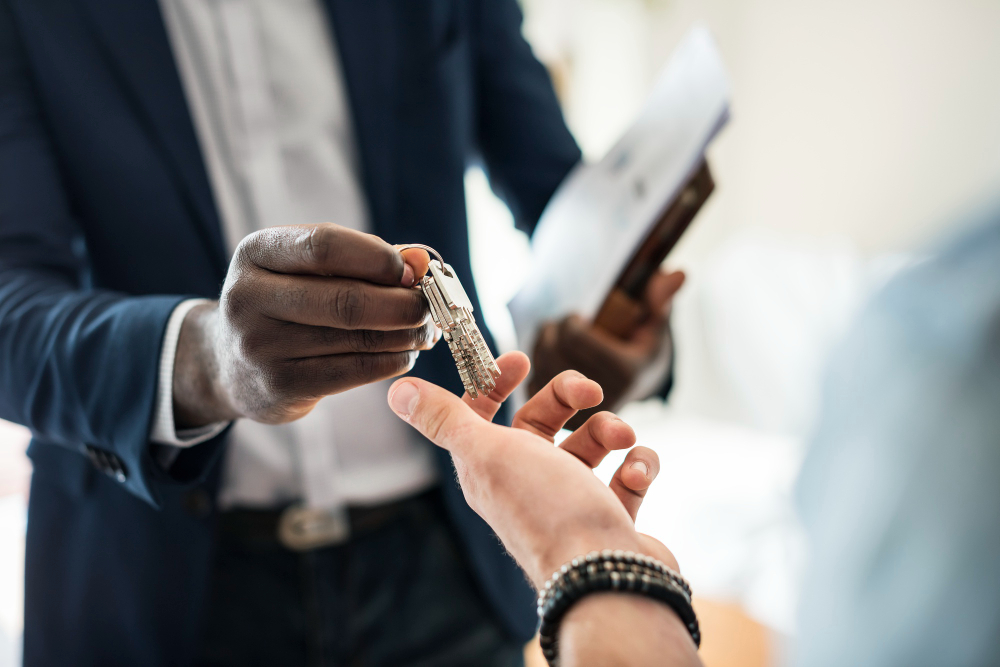 agent handing the house key to a client