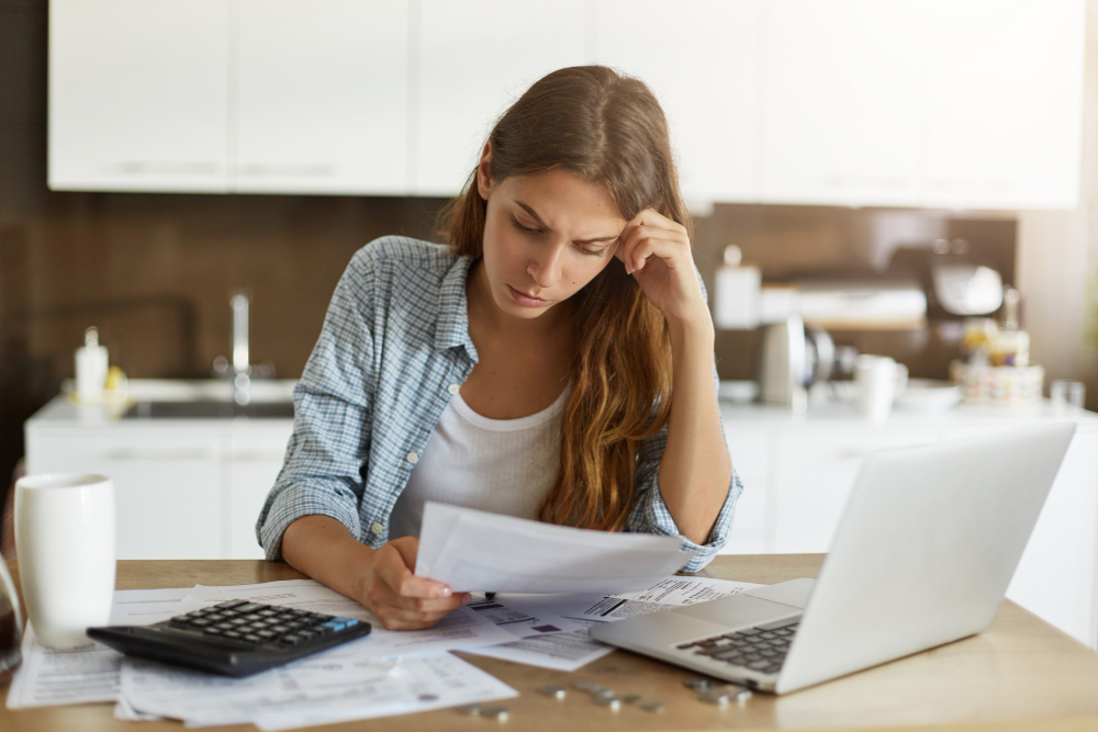 Woman reviewing tax documents at home