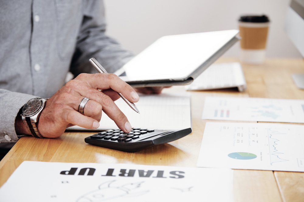 Self-employed professional reviewing tax documents at a home office.