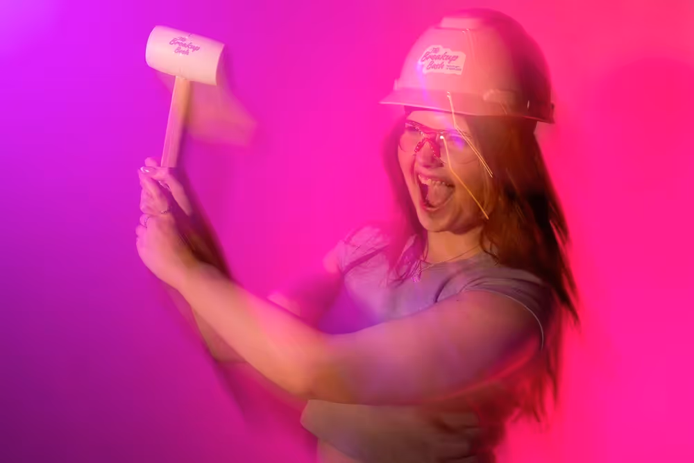 Person swinging a mallet with motion blur under pink and purple lighting, lifestyle photography by Photos by Lars.