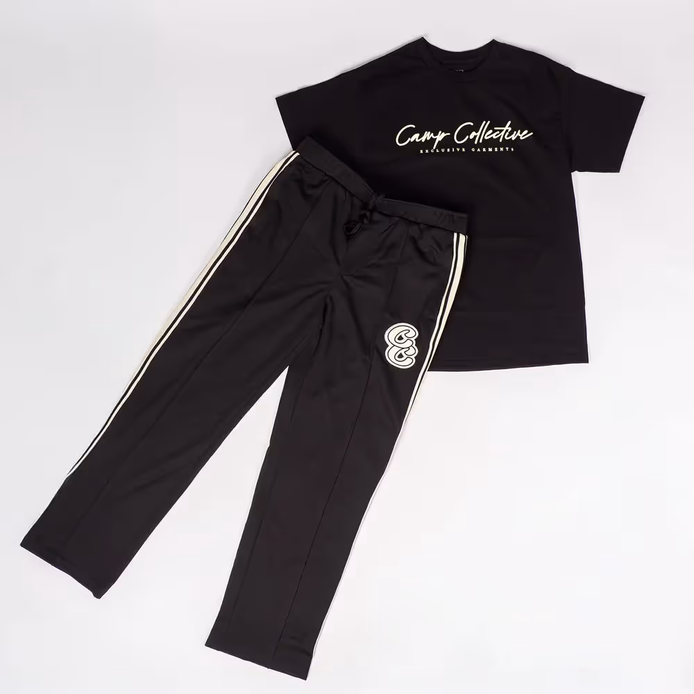 Black Camp Collective tee paired with black pants in flat lay, ecommerce apparel photography by Photos by Lars.