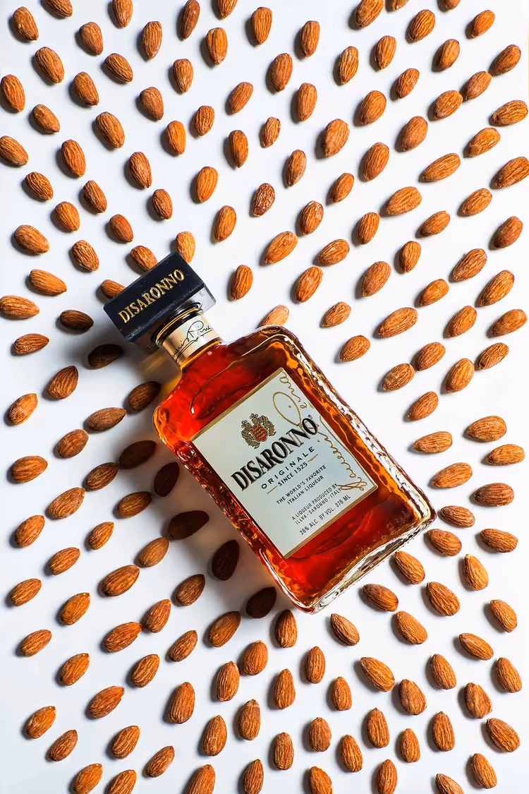 Disaronno bottle centered on radiating almond pattern, ecommerce photography by Photos by Lars.
