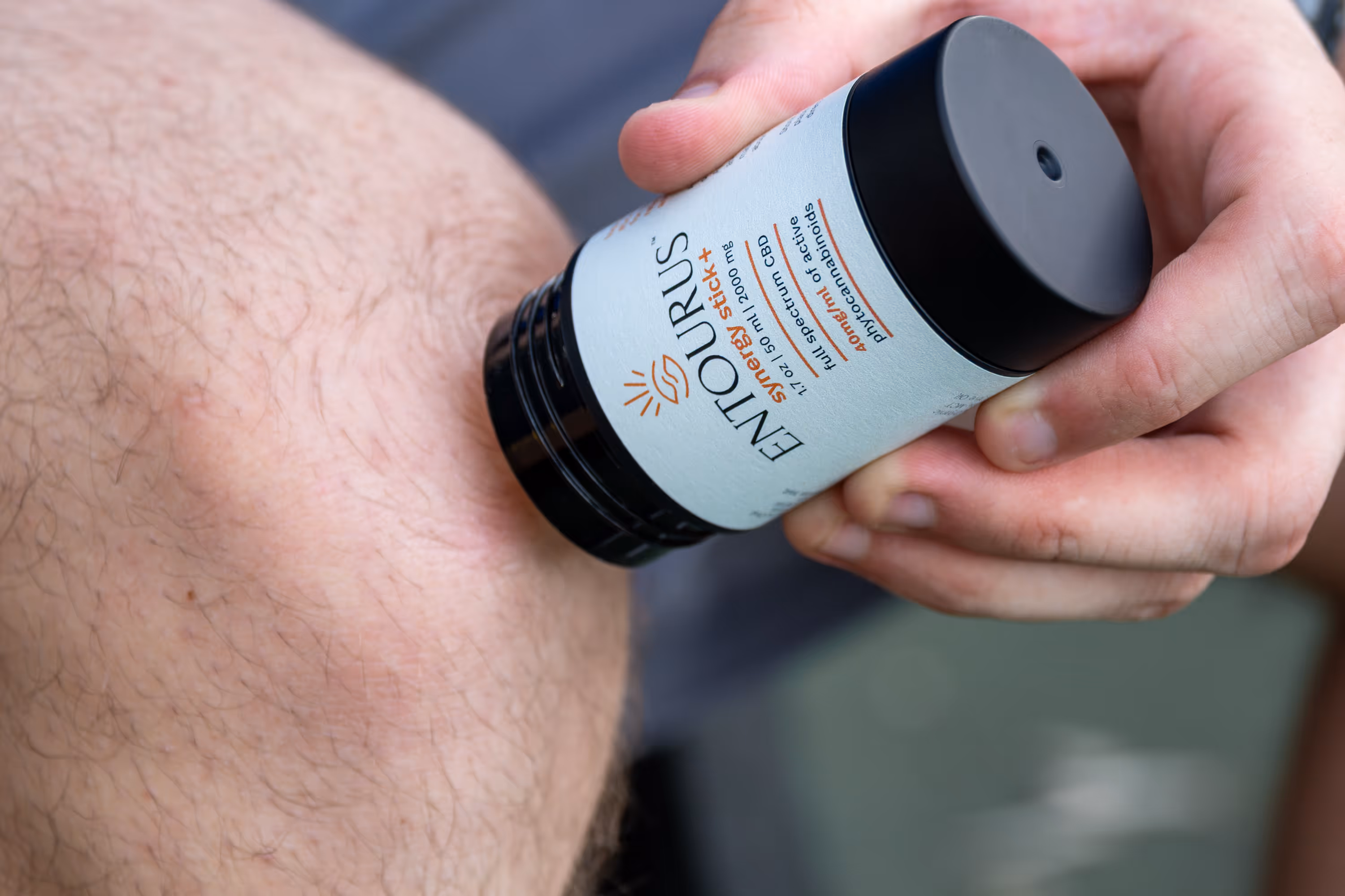 Entourus stick applied near a bent knee in both hands, lifestyle product photography by Photos by Lars.