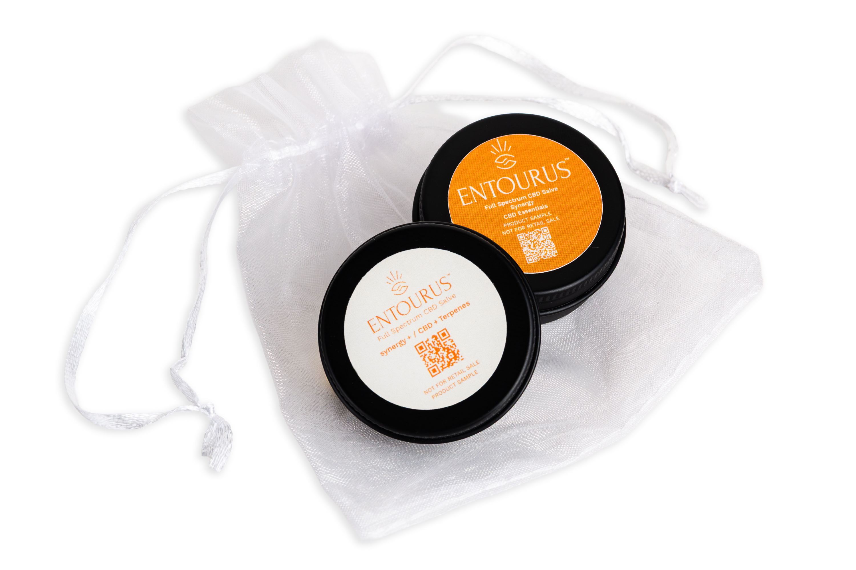 Entourus CBD salve sample tins on white drawstring pouch, orange and white labels, product photography, Photos by Lars.